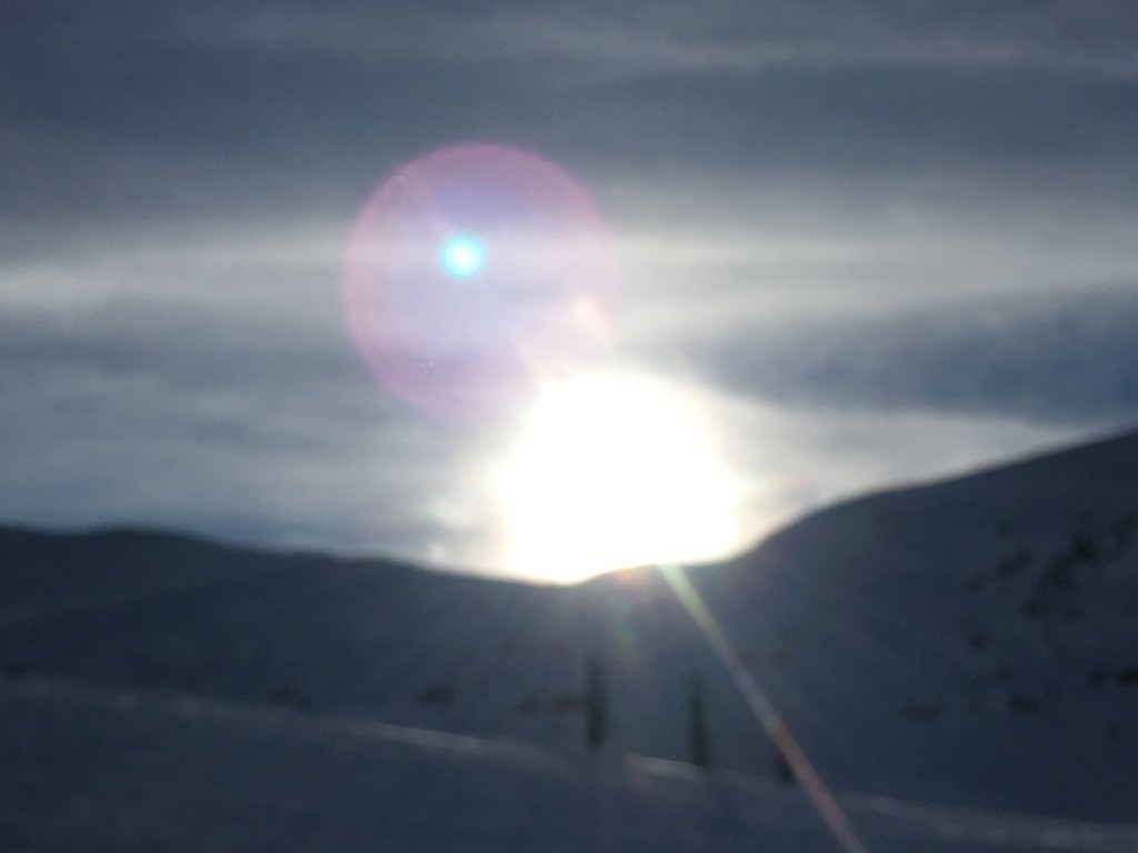 Low sun flaring over the ridge at the end of the day